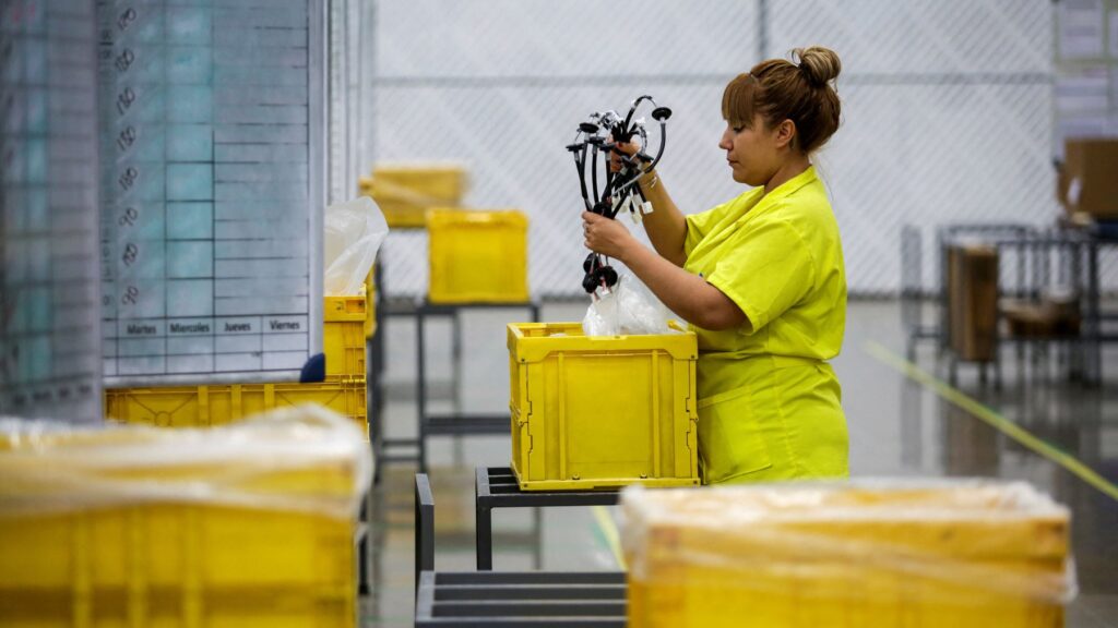 FILE PHOTO: An employee works at Ark de Mexico, an assembly factory that makes wire harnesses and electric components for the automobile industry, in Ciudad Juarez